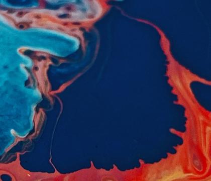 paint swirls in bright orange and dark blue