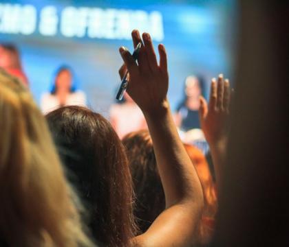 Conference attendee raising hand