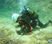 student collects artifacts on the ocean floor