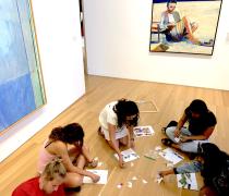Student Guide doing K12 activity in an art gallery with visitors.