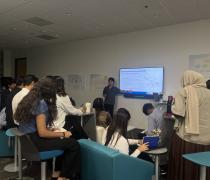 Tyler Yang - 2026 Fellowship Recipient; Tyler is presenting to a group of students.