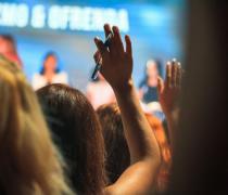 Conference attendee raising hand